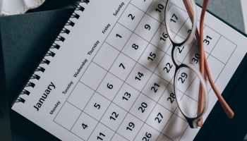 brown framed eyeglasses on a calendar